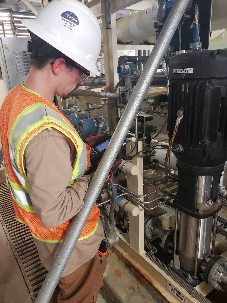 Technician performing vibration analysis on rotating equipment